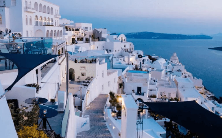 Santorini, Greece White buildings with blue sea view – very famous sunset destination.