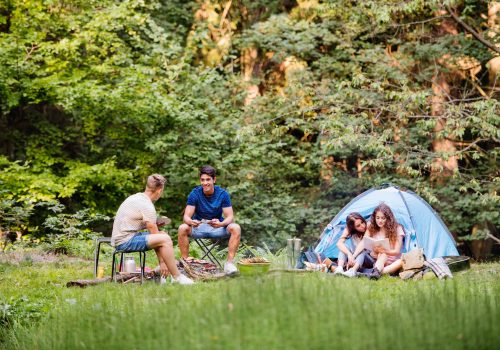 teenagers-camping-in-forest-summer-adventure-.jpg